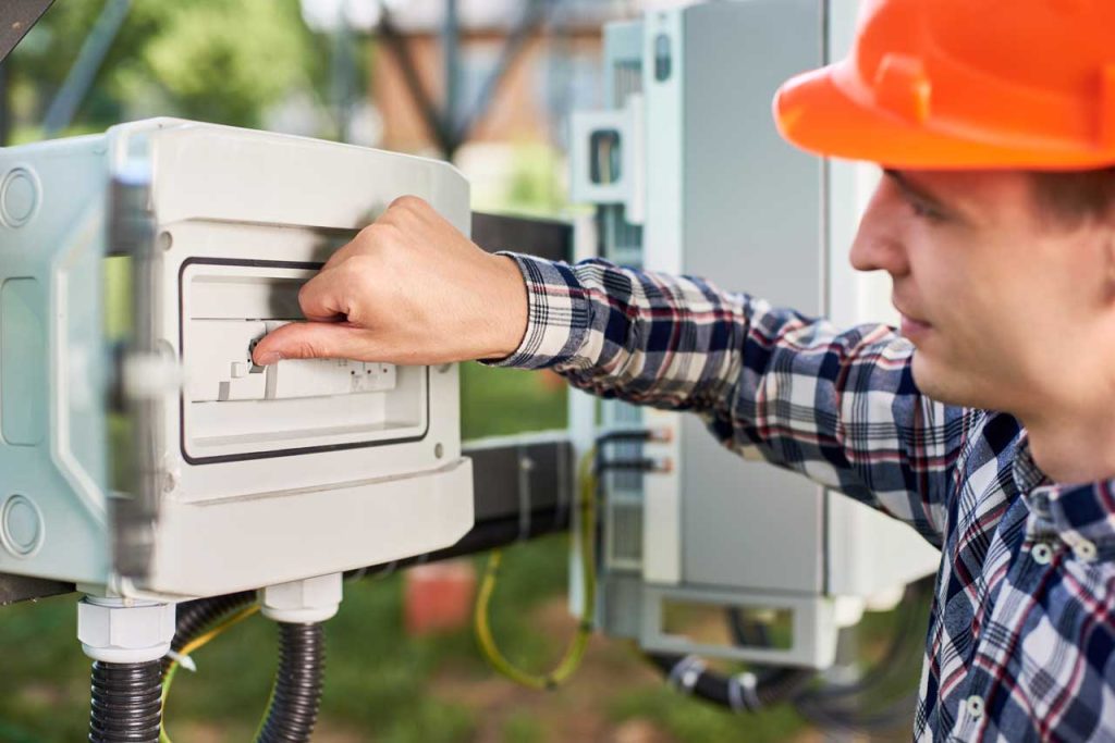 A skilled electrician working on a residential electrical system
